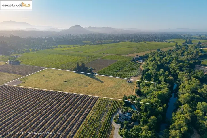 Overview of rural landscape with a mountain backdrop and property boundaries highlighted