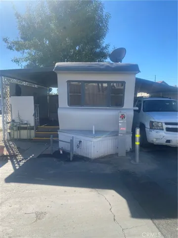 Front view showing patio to the left and parking to the right