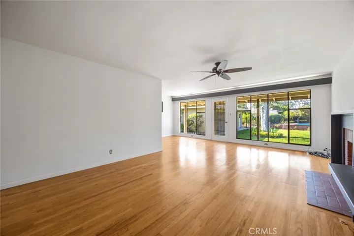 The living room at 10357 Lesterford Avenue looks out onto the beautiful yard, swimming pool, and formal dining area.