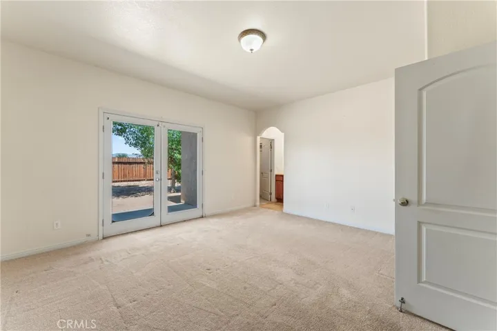 Primary Bedroom (Size: 14'9" x 14'4") French Doors lead to Private Backyard