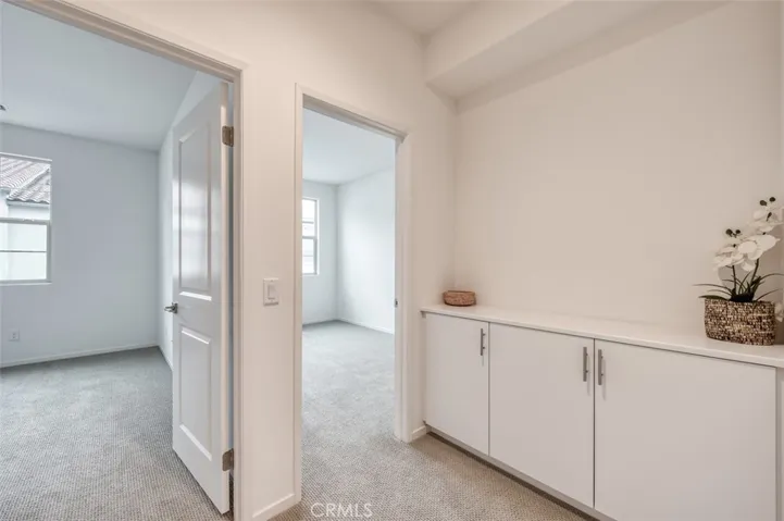 Secondary bedroom entrances with built-in hall storage.