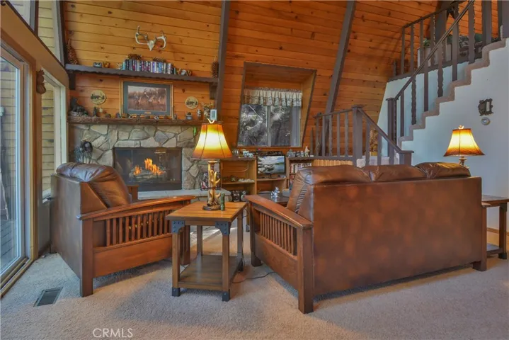 Living Room with Stone wood burning Fireplace Fully Furnished -  Fire in Fireplace digitally added