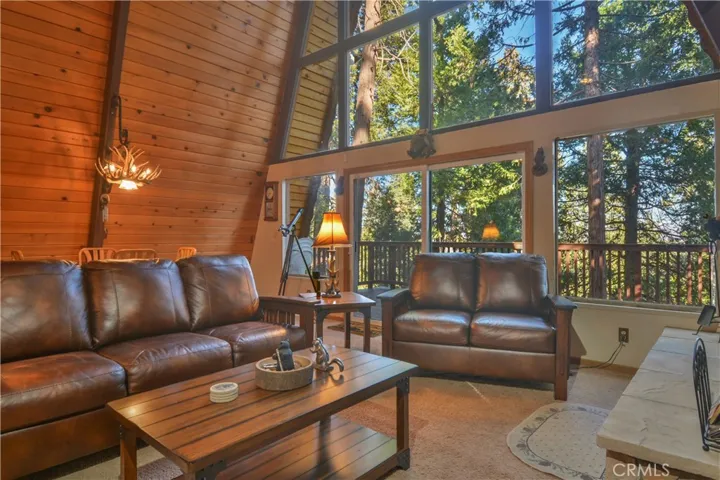 Living Room with Dining Area and Full Tree Views