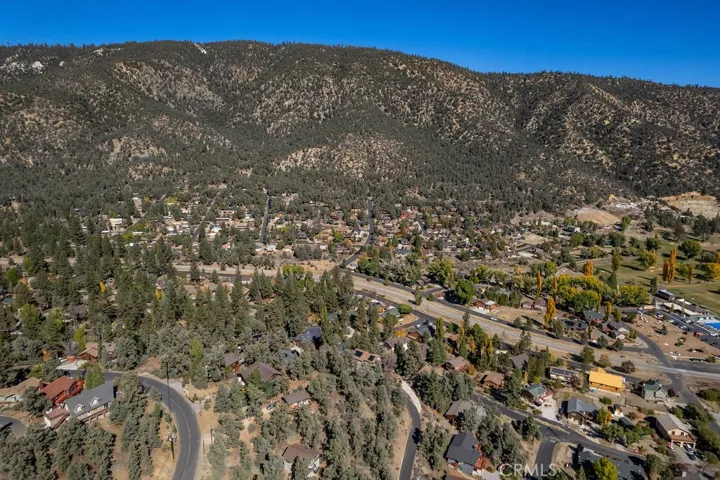 In the lower center of the photo, on the inside curve lie three undeveloped lots. The subject property is the middle one.