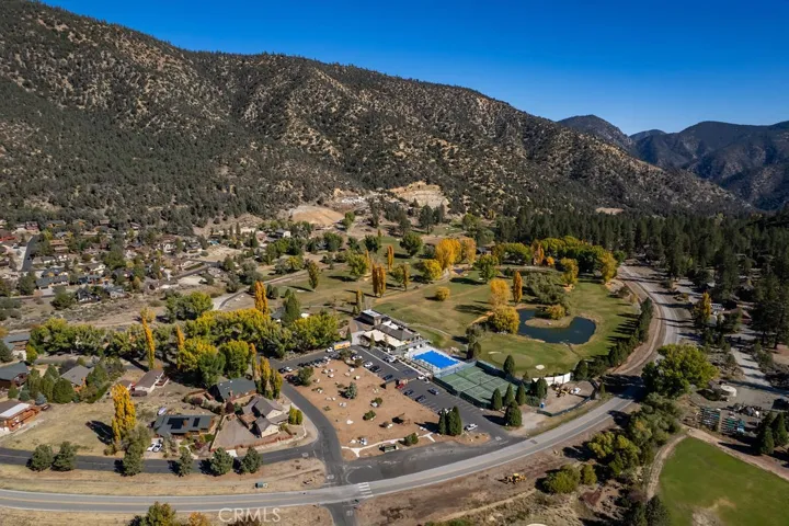 The clubhouse with pool, tennis/pickleball courts and golf course are seen here with Mil Potrero Highway providing access to the facilities.