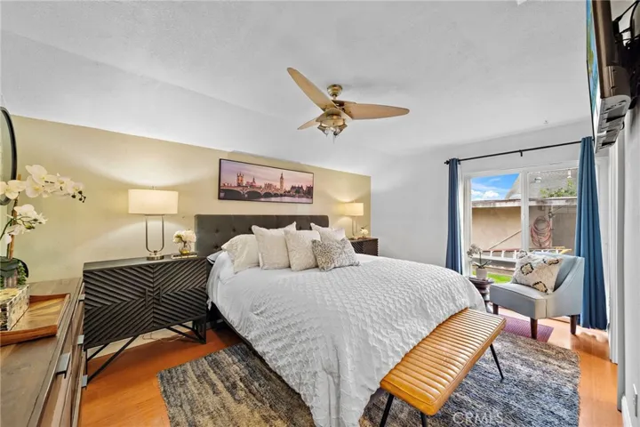 Primary suite offers a peaceful retreat with a ceiling fan, abundant natural light