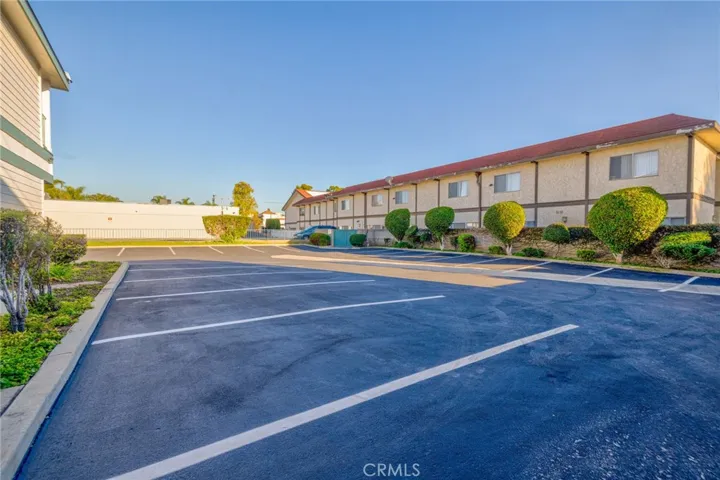Recently resurfaced parking lot with 26 parking spaces and enclosed trash area