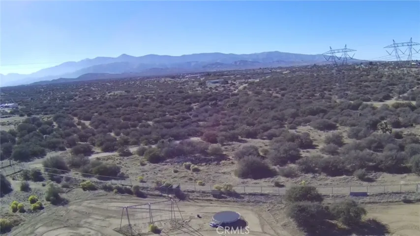 Aerial view of property looking south showing San Gabriel Mountain range and rear view of property