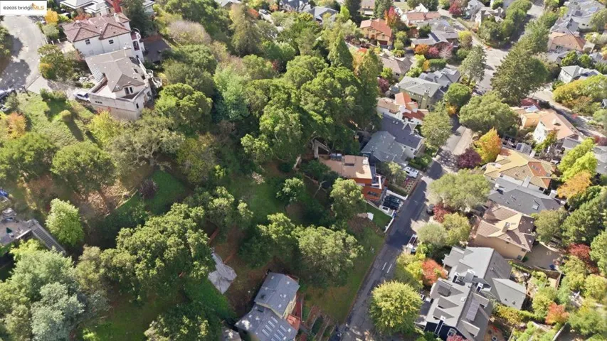 Aerial view of property and surrounding area with nearby suburban area