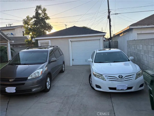 Cars park inside gate and garage door
