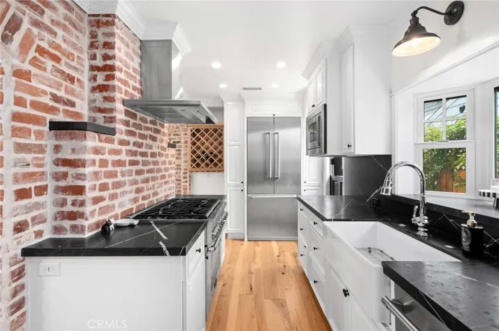The thoughtfully designed chef’s kitchen showcases rich soapstone countertops, a charming bay window, exposed beamed ceilings, and top-tier appliances, including a suite of Thermador​​‌​​​​‌​​‌‌​​‌​​​‌‌​​​‌​​‌‌​​‌‌​​‌‌​​​​ appliances.