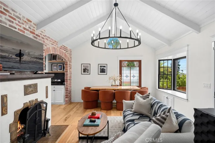 The open floor plan highlights timeless details such as original stained-glass windows, custom doors, and intricate brickwork.