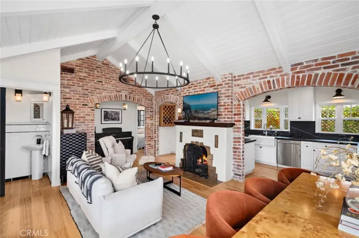 Meticulously updated inside and out, the sun-kissed interior features custom hickory floors, brick accents, beamed ceilings, and an abundance of architectural charm.