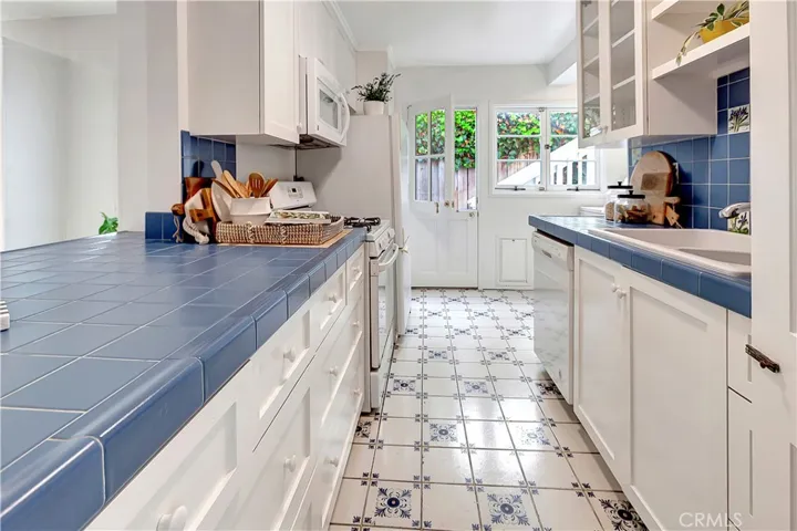 Kitchen has Dutch door leading to side yard. Also, the washer and dryer are there on the right tucked away.