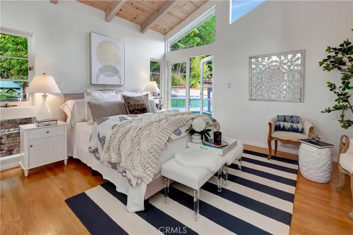 Primary bedroom and ensuite with French doors leading to the backyard and spa