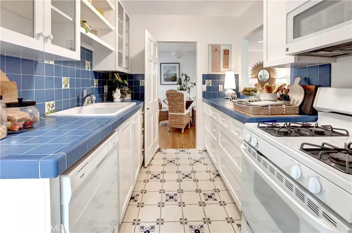 Galley kitchen leading to dining area