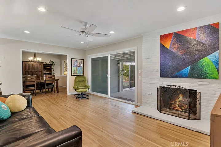 Living Room
Front door with glass inserts
Energy efficient dual pane windows
Smooth ceilings 
Crown molding
Ceiling fan
LED recessed lights
Floor-to-ceiling fireplace in white-painted brick
Oversized sliding glass door leading to the backyard
Rich hardwood floors