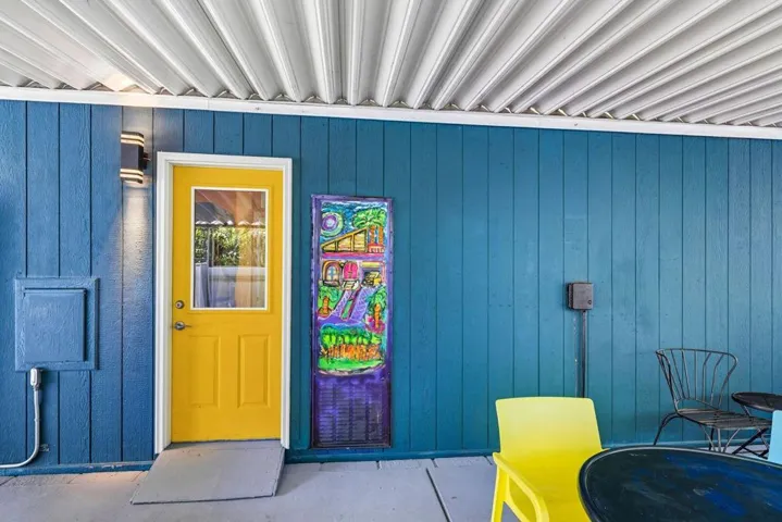 Covered patio space behind carport wall