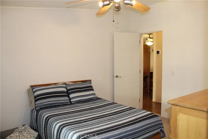 Guest bedroom with TV and walk in closet