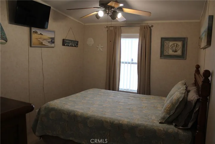 Guest bedroom with TV and walk in closet