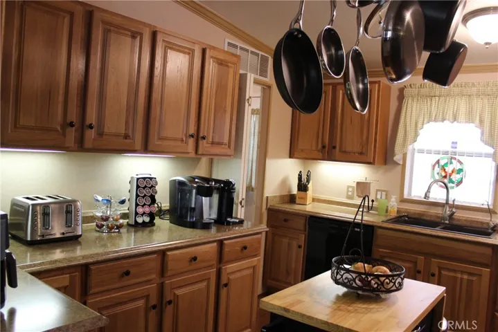 Kitchen with portable island and pot rack