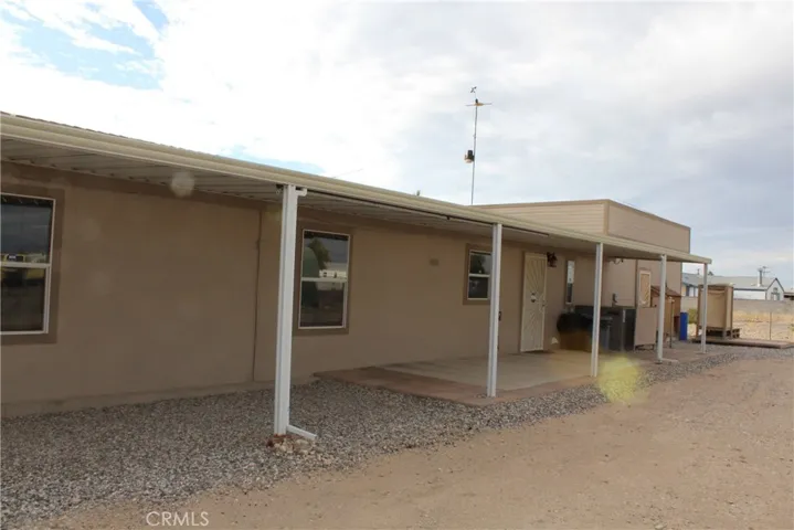 back porch patio with 2 pull down sunshades.  Can also be used for covered vehicle storage