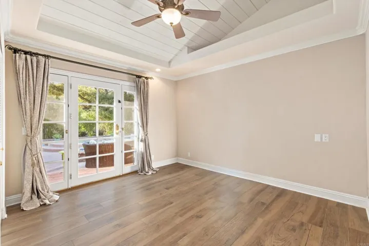 On back side of home w/french doors to pool area. Open Beam Ceiling w/recessed lighting and fan