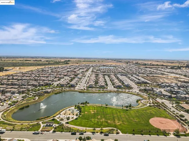 Aerial overview of property's location with a nearby body of water and nearby suburban area