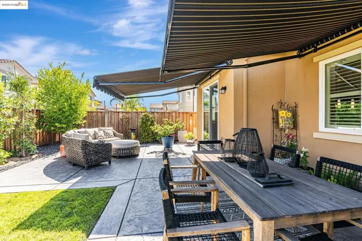 Fenced backyard with outdoor dining area, an outdoor living space, and a patio area