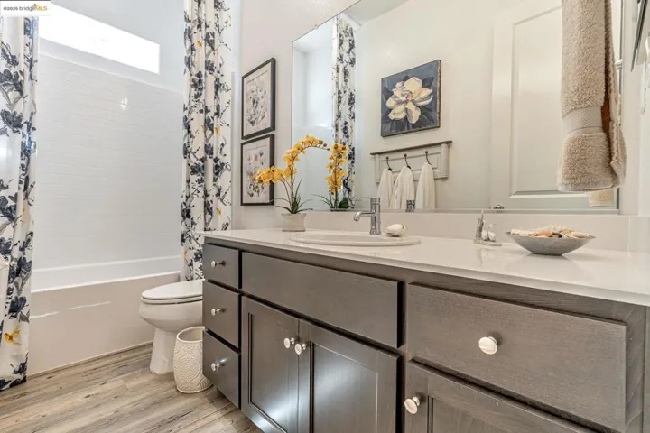 Full bathroom featuring vanity, light wood finished floors, and shower / bath combo