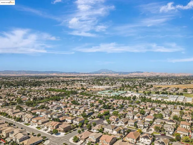 Aerial perspective of suburban area with a mountainous background