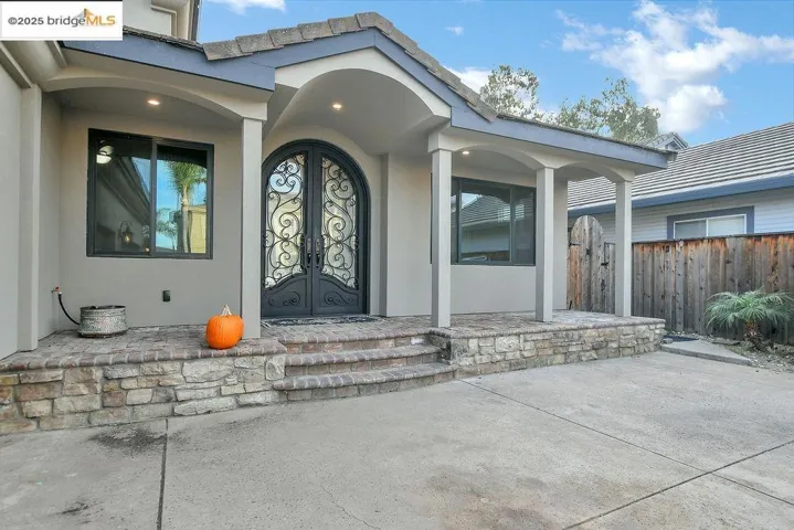 Property entrance featuring stucco siding