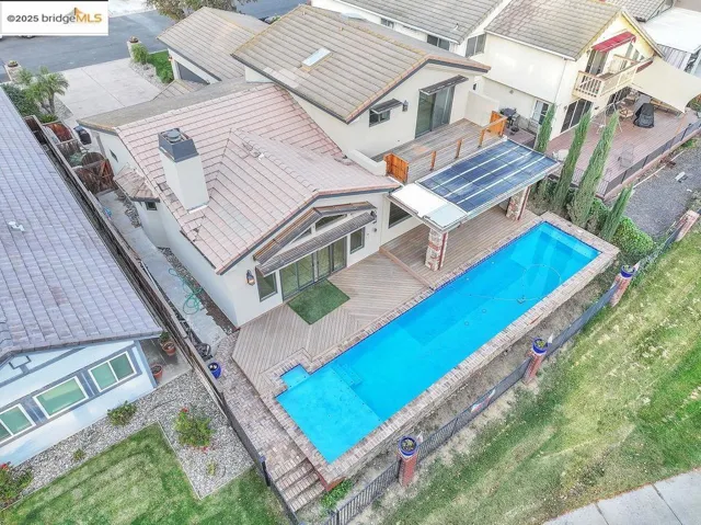 Aerial view of residential area featuring a pool