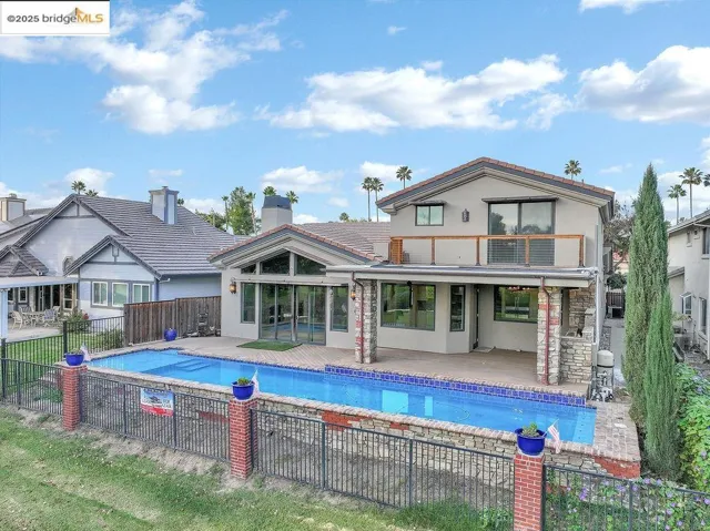 Back of property with stucco siding and a patio area