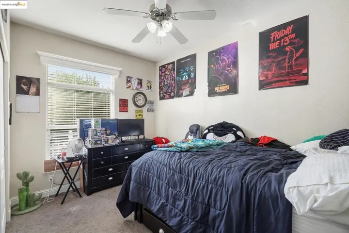 Bedroom with carpet and a ceiling fan