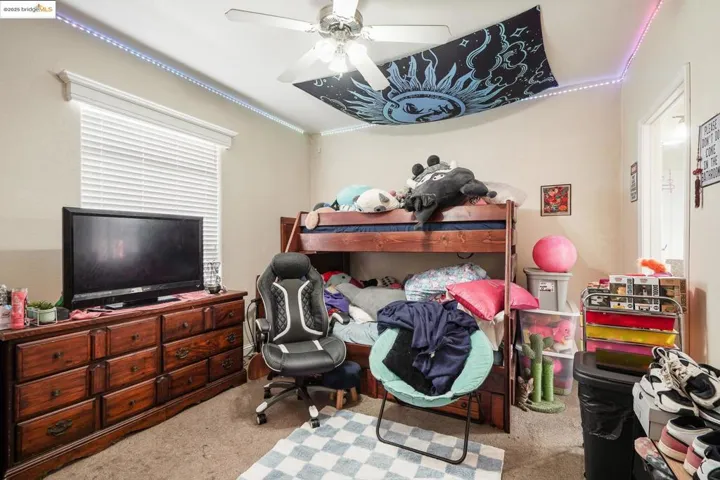 Bedroom featuring carpet floors, a ceiling fan, and ornamental molding
