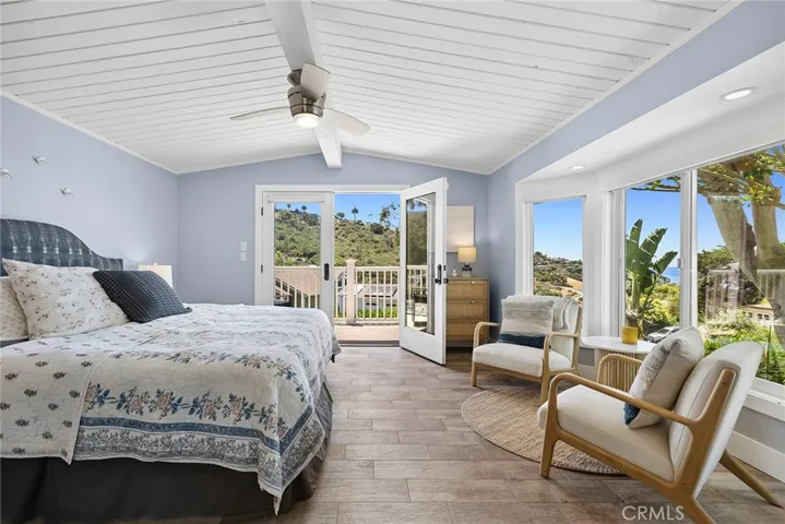 Primary bedroom with ocean view and deck