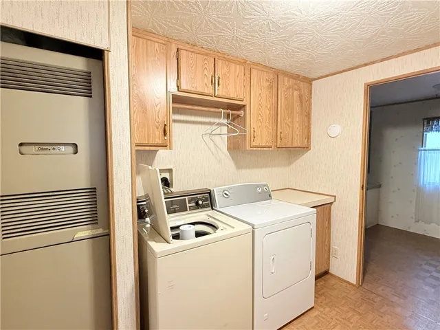 Laundry room, adjacent to primary bathroom