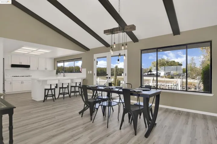 Dining room with light wood-style flooring and french doors