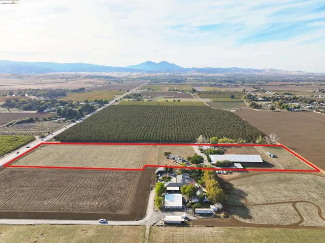 Aerial view of sparsely populated area featuring farmland and property boundaries highlighted