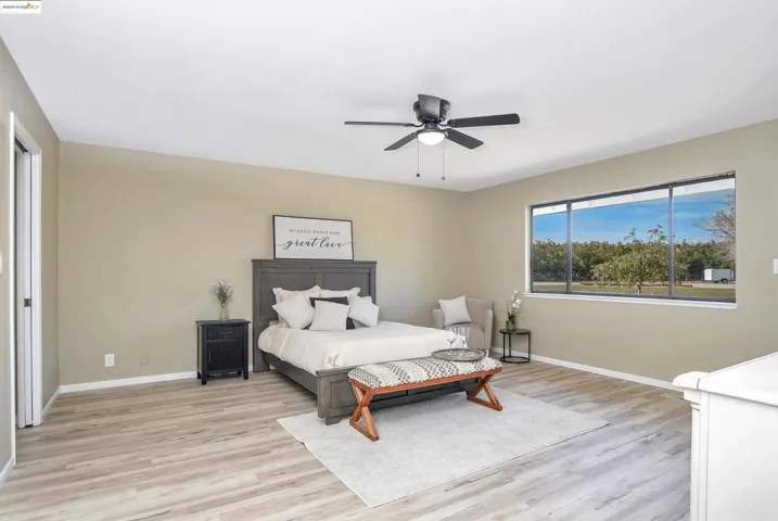 Bedroom with light wood-style flooring and ceiling fan