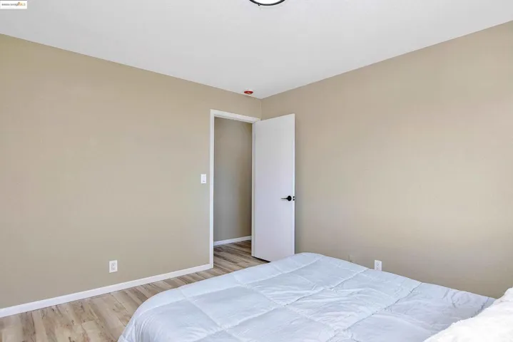 Bedroom featuring light wood-style floors and baseboards