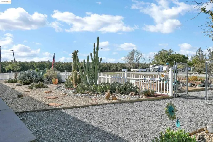 Community / neighborhood sign featuring a gate