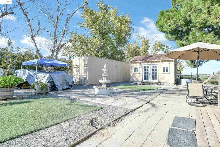 View of patio featuring an outdoor structure
