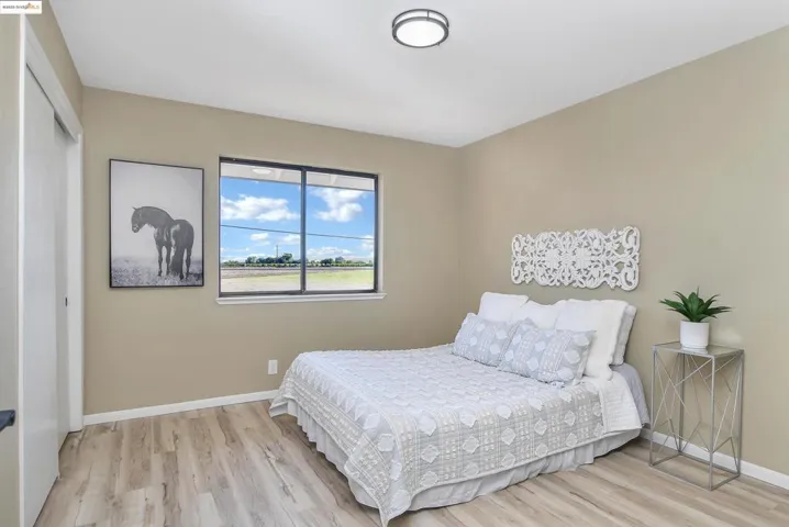 Bedroom with light wood-style floors and a closet