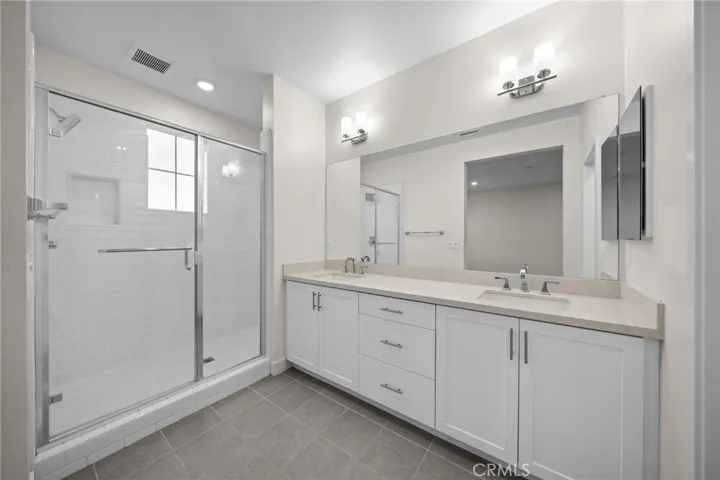 Primary Ensuite with Dual Vanity, Shower, and Separate Toilet.
