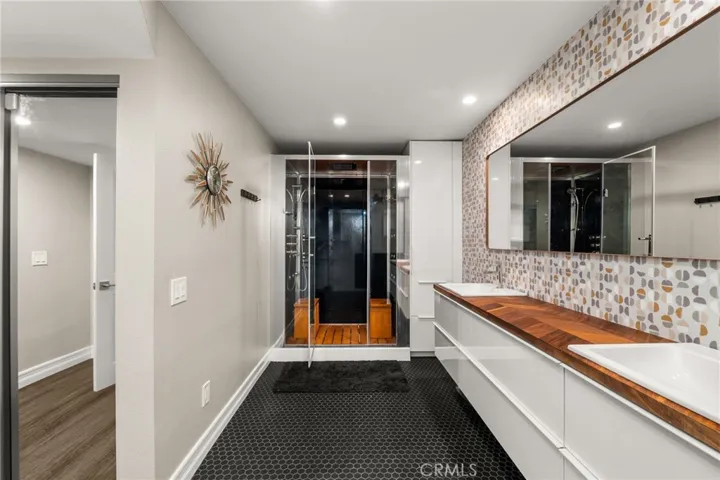 Designer primary bathroom with steam shower.