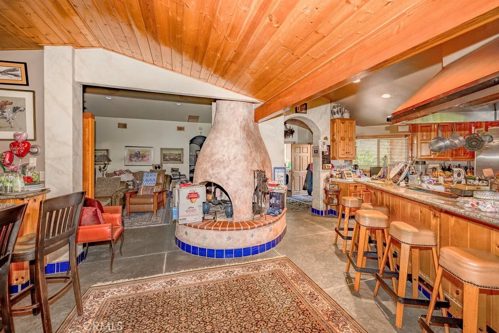 on the left is a separate bar to the right is the kitchen and view to the media room