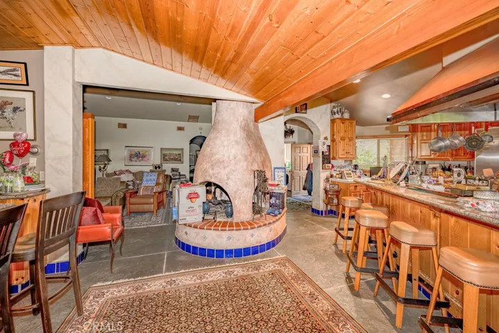 on the left is a separate bar to the right is the kitchen and view to the media room