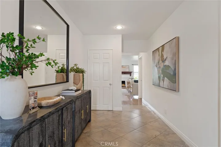 Spacious tiled entryway with coat closet